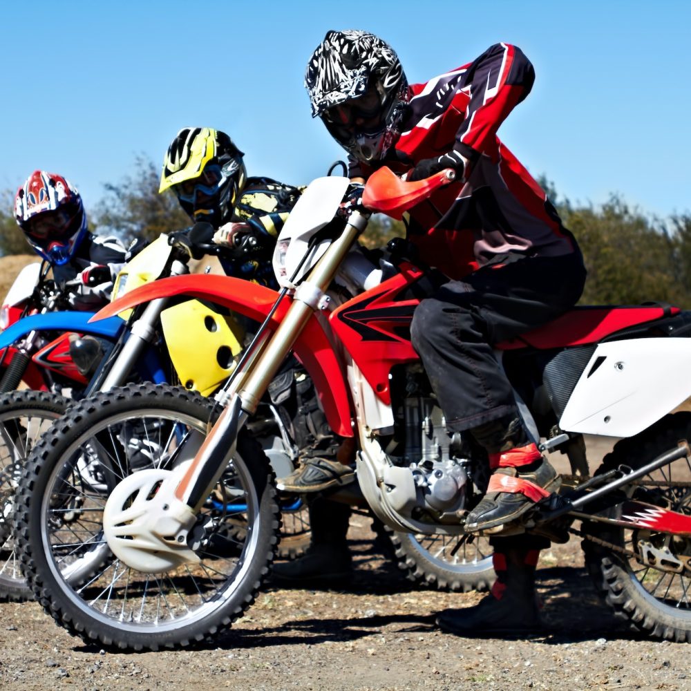 Showing off their wheels. Three bikers sitting on their motorcycles ready for a race.